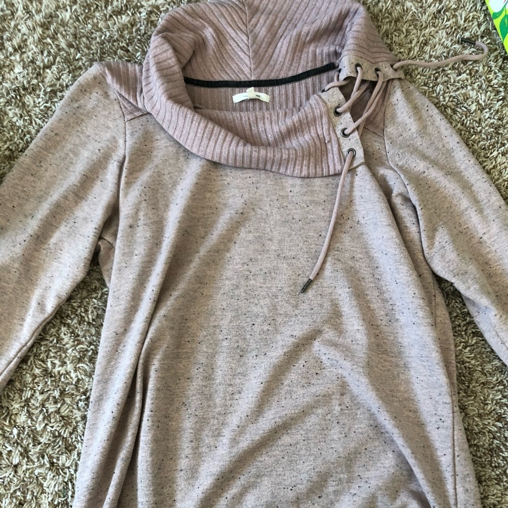 A turtleneck pink sweater
